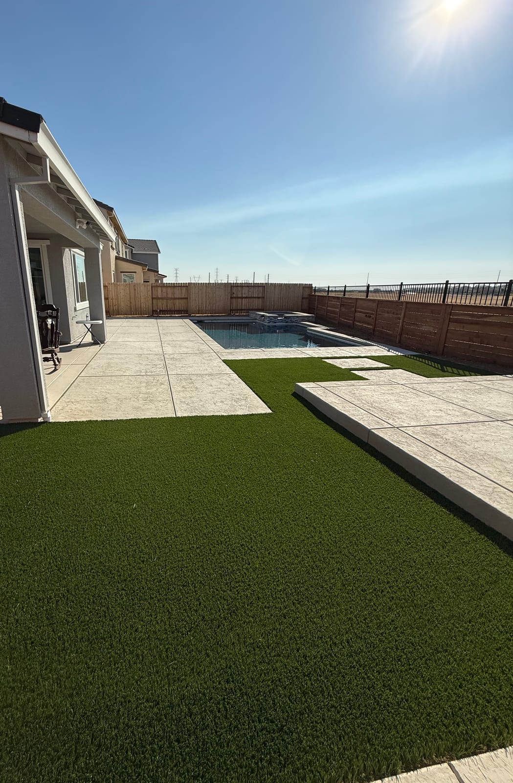 Finished outdoor living space with patio and landscaping by CJR