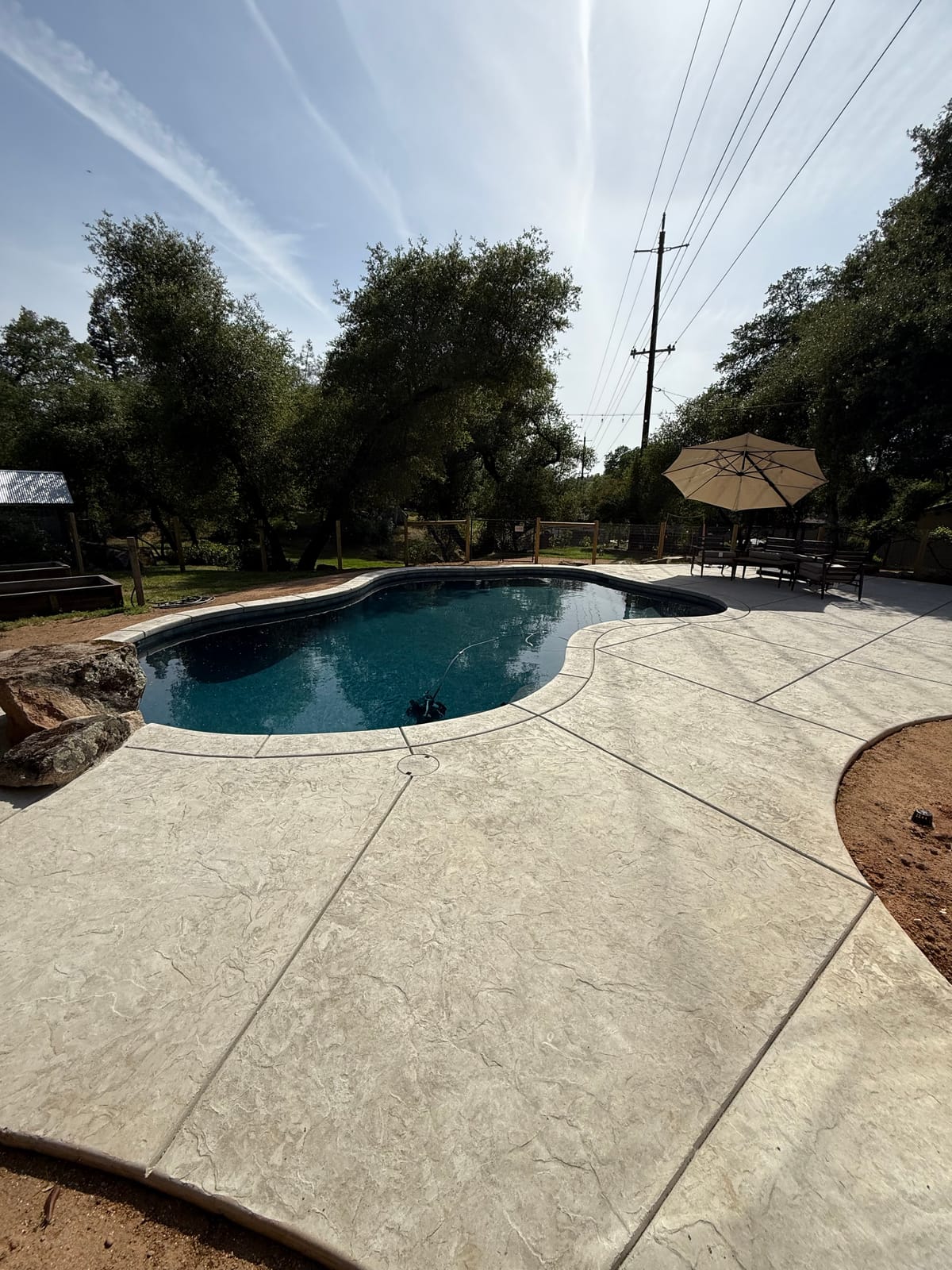Custom pool with tanning ledge and spa by CJR