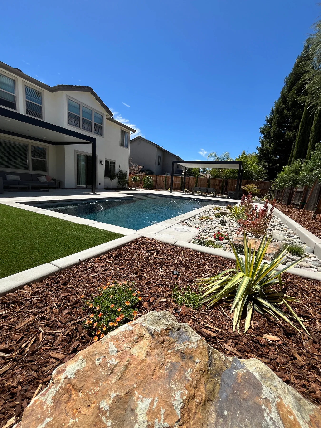 Poolside landscaping project by CJR Concrete & Landscape Construction