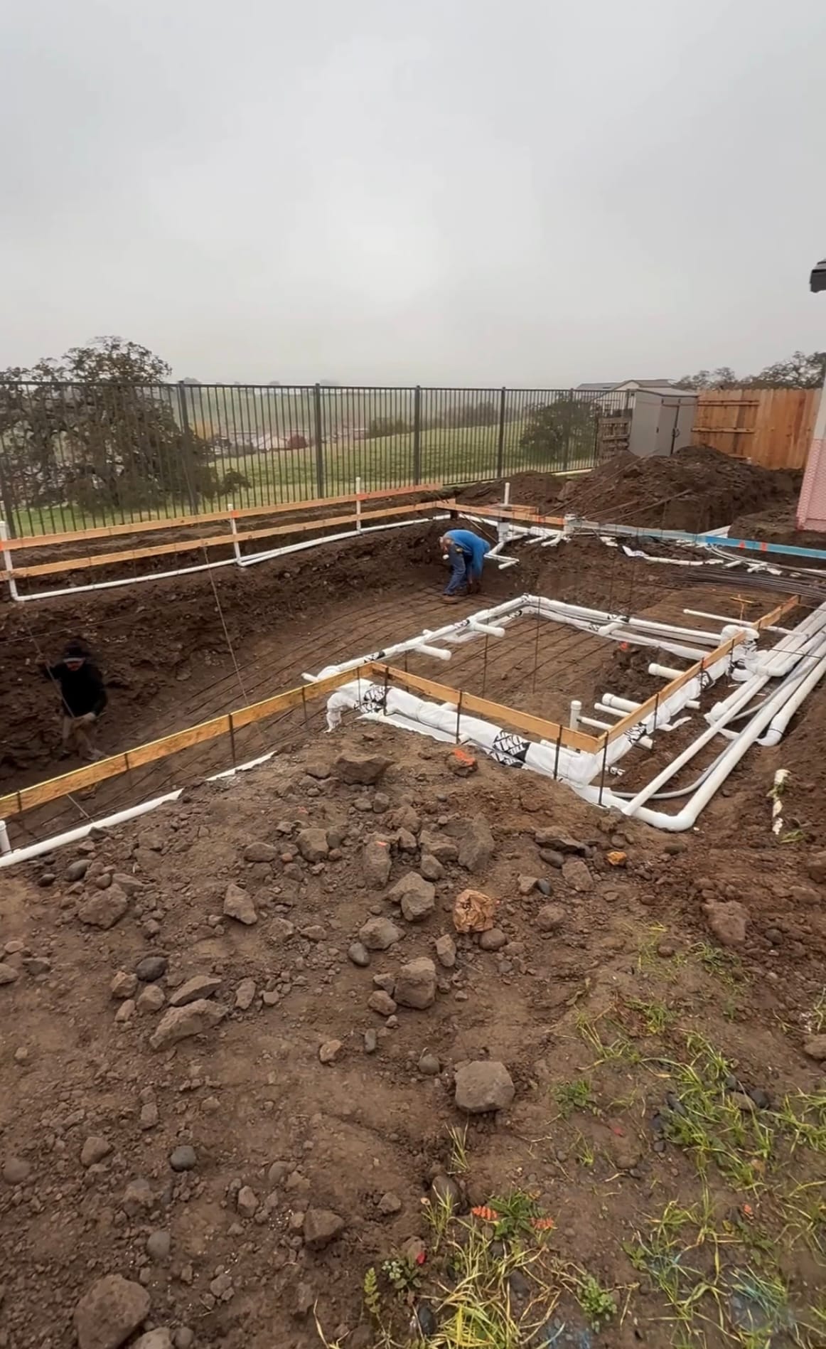 Pool plumbing lines and electrical runs installed around the pool shell