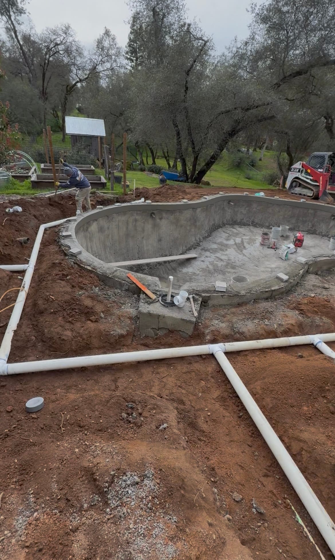 Custom drainage system installed around a new pool and hardscape