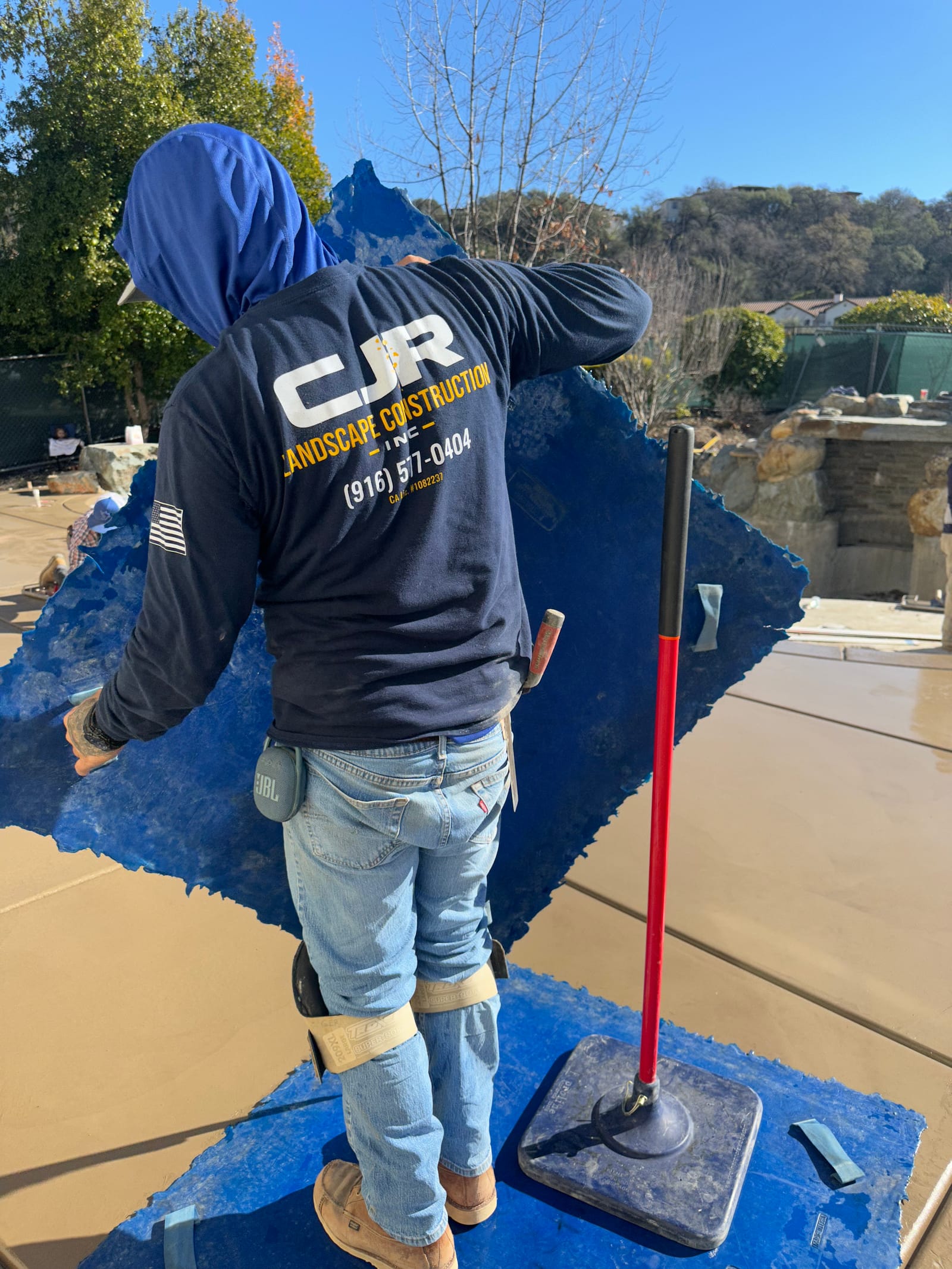 CJR crew member finishing fresh custom concrete pool decking
